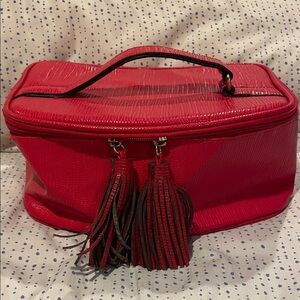 Elizabeth Arden Red train cosmetic zipper makeup case with top handle.